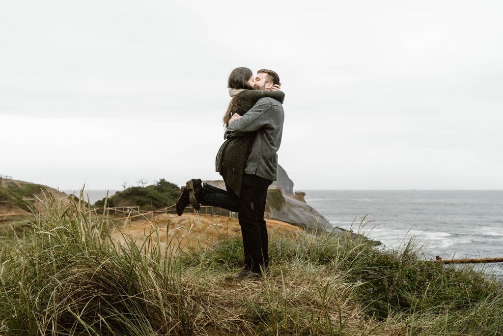 Couple kissing in the rain at Cape Kiwanda