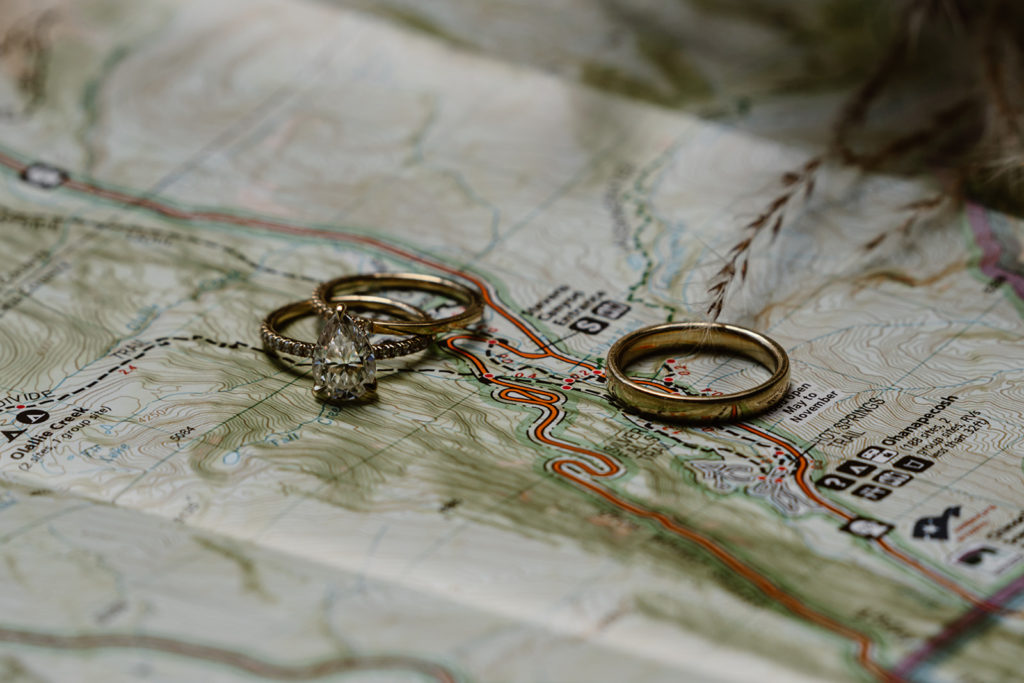 Wedding rings on top of a map of mt. rainier during a mt. rainier wedding