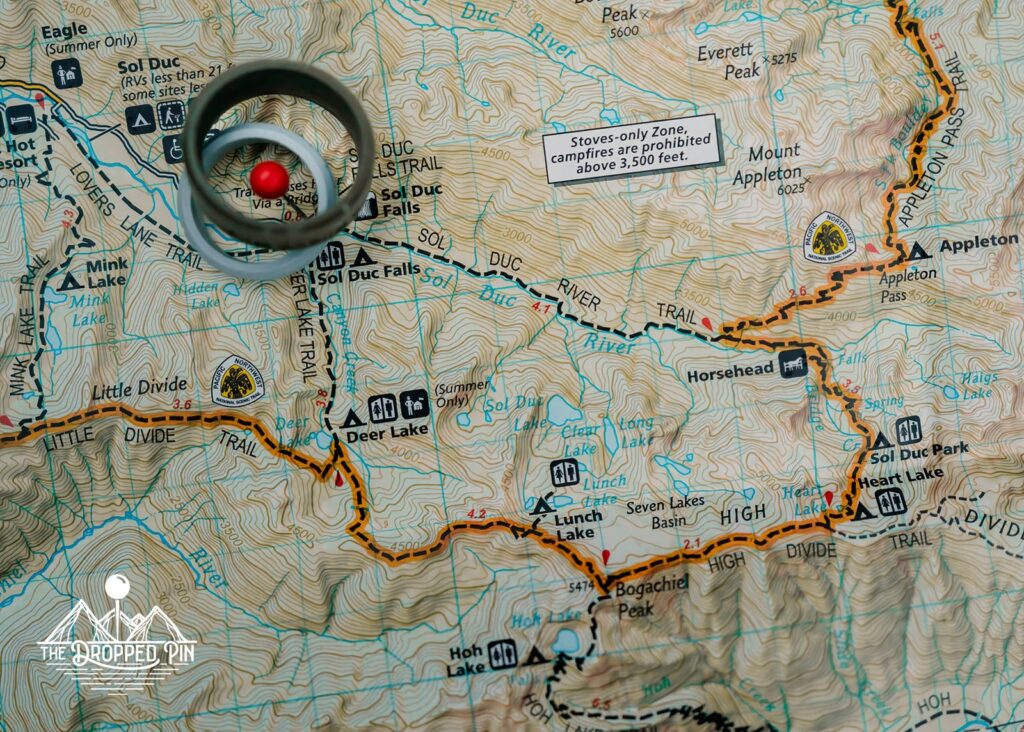 A olympic national park map with rings stacked over the location of this Washington elopement
