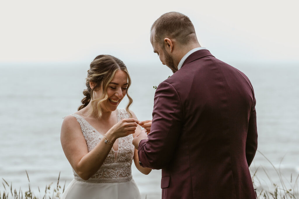 A bride smiles as she receives a precious gift from her groom