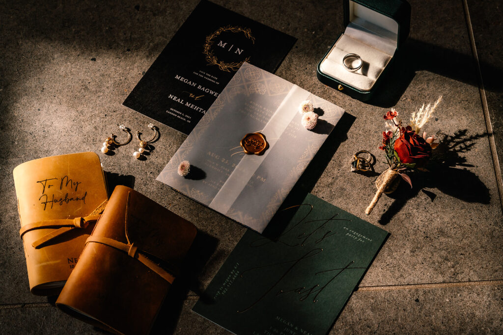 the details of an elopement day sprawl out on the floor. golden light creates cinematic highlight and shadow that draw the eye 