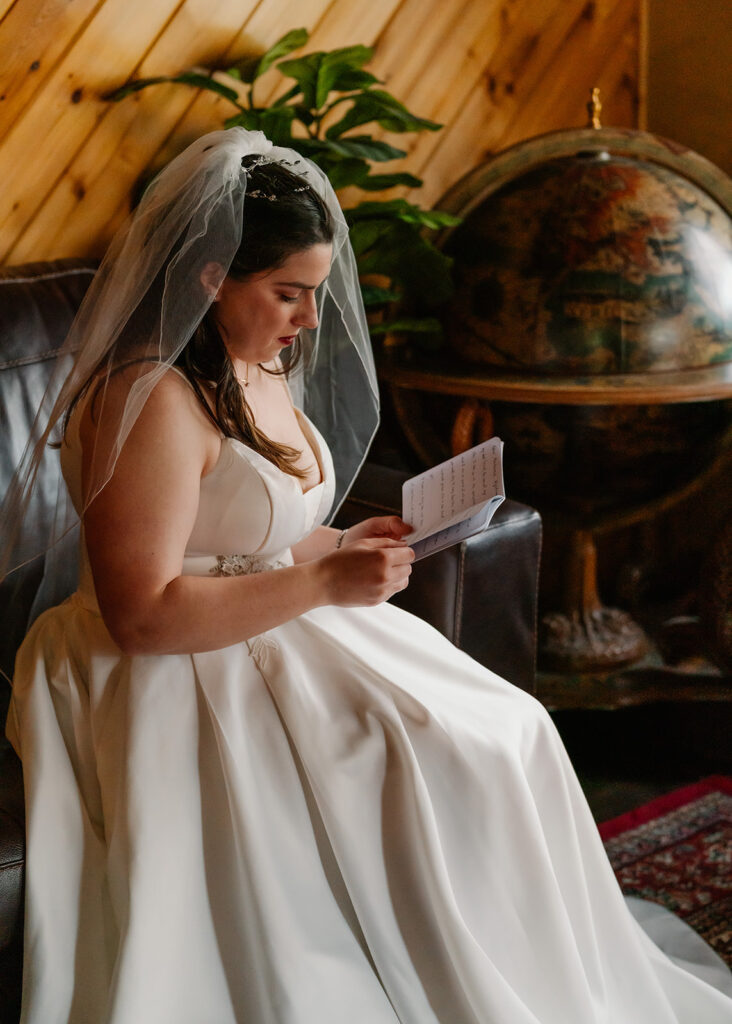 A bride reads over her vows before her lake crescent wedding. 