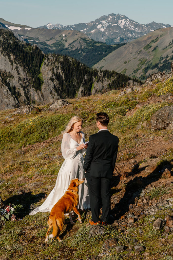 a bride smiles sweetly as she reads hfer vows to her groom during their Olympic Peninsula elopement. 