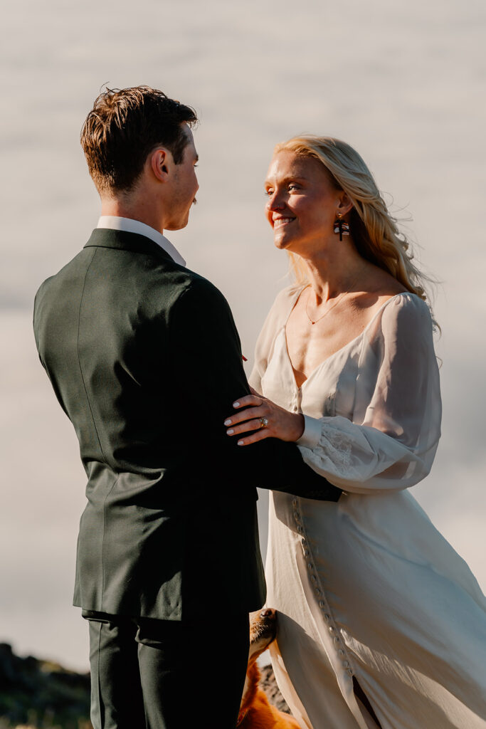 a bride smiles widely at her groom during their Olympic Peninsula elopement. 