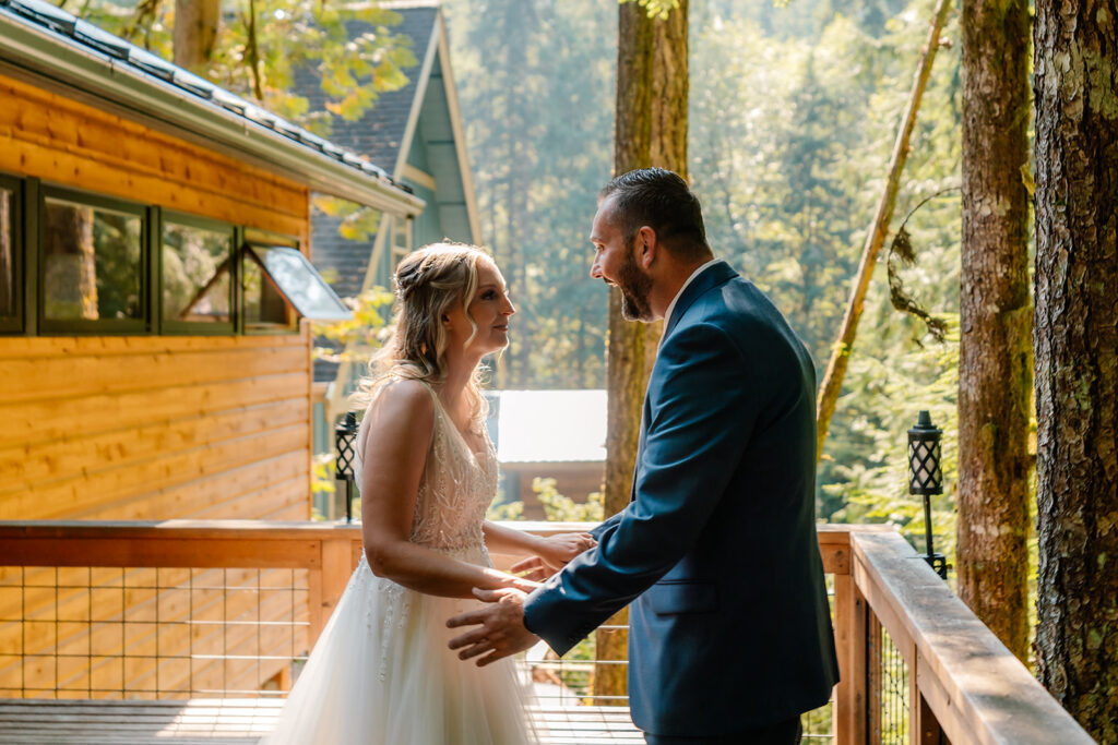 a sweet moment just before a big embrace during a first look. a groom over joyed to see his bride exclaims and she moves into his arms 