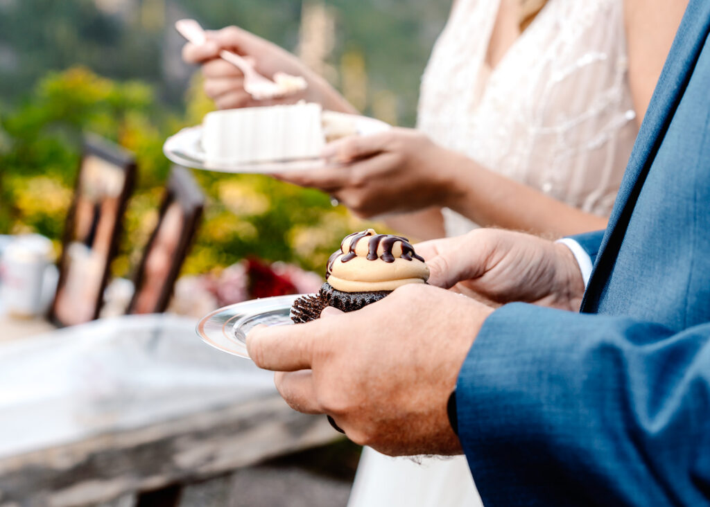 a shot of a chocolate peanut butter cupcake held by the groom to celebrate this mt baker micro wedding 