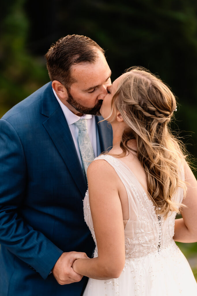 a shot of a bride and groom sharing a deep kiss 