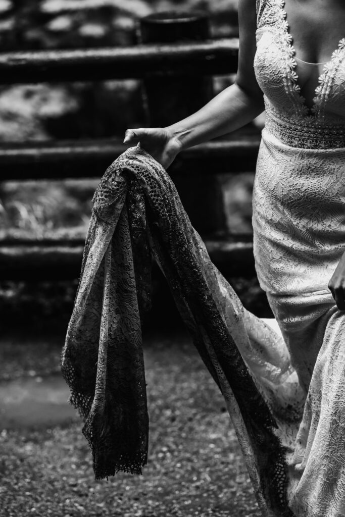 a black and white image of the train of a wedding dress. It is sopping wet with mud and, dirt, and adventure.