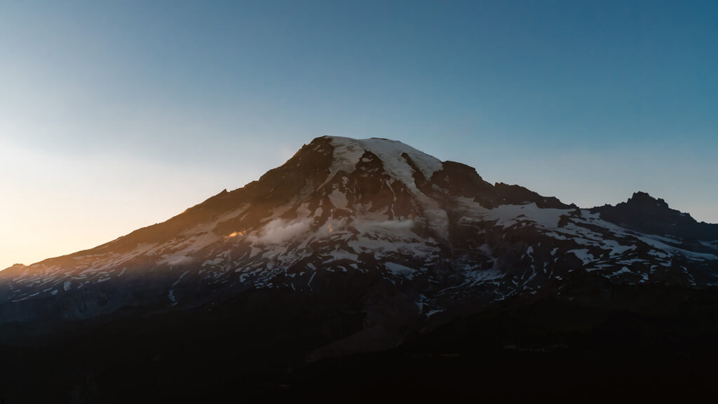 a stunning landscape shot of mount rainier as blue hour begins