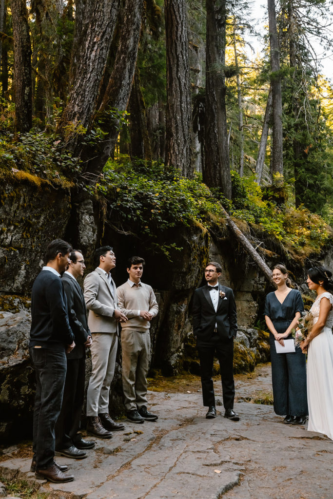 mt rainier wedding party gathers at their location. the groomsmen sing as everyone gazes at them