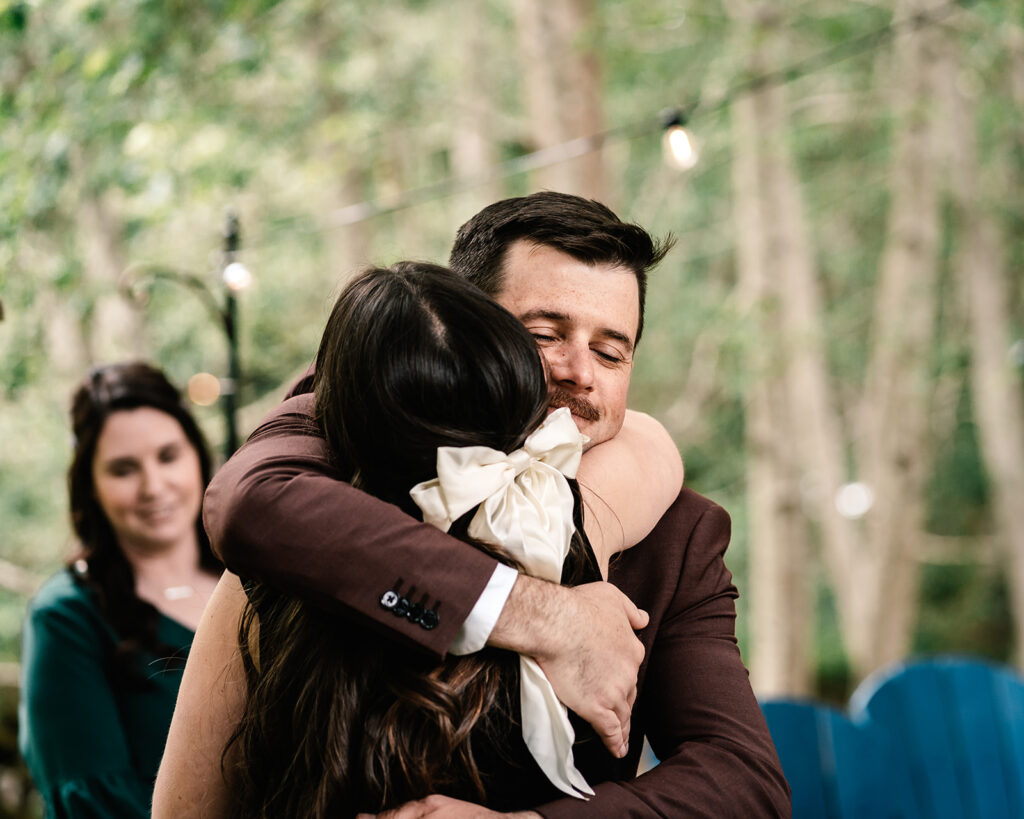 the groom hugs his friend