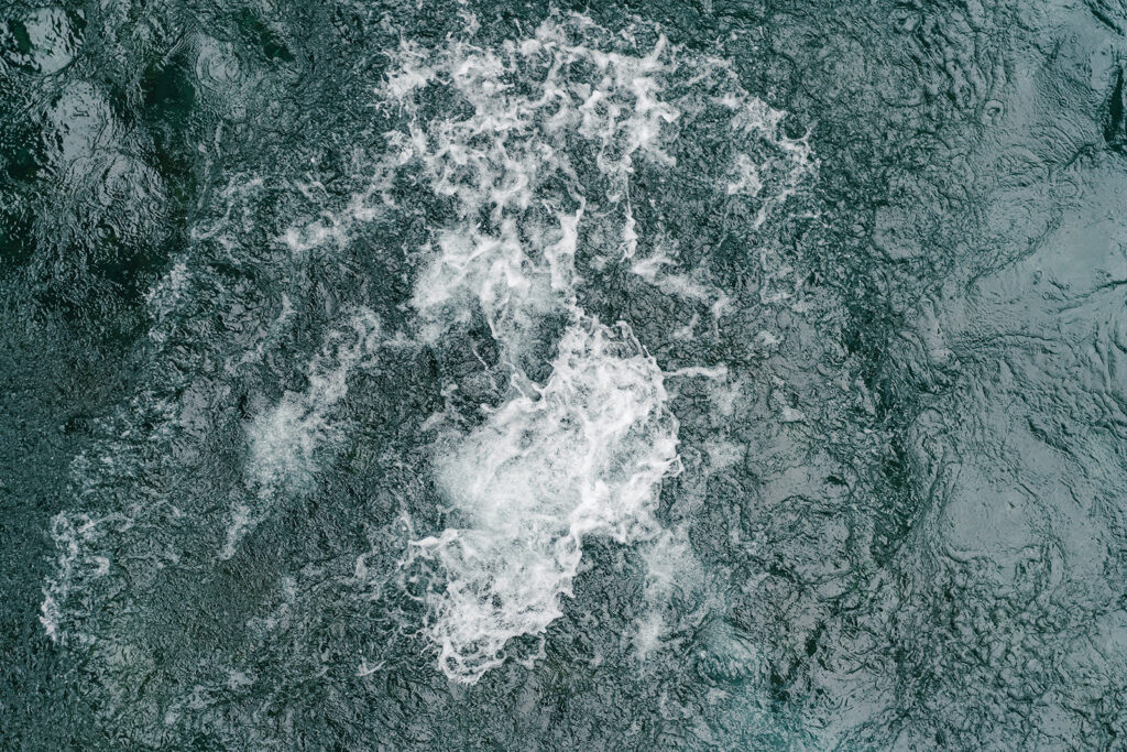 splashes and ripples in the river water from the fall of the brides rock