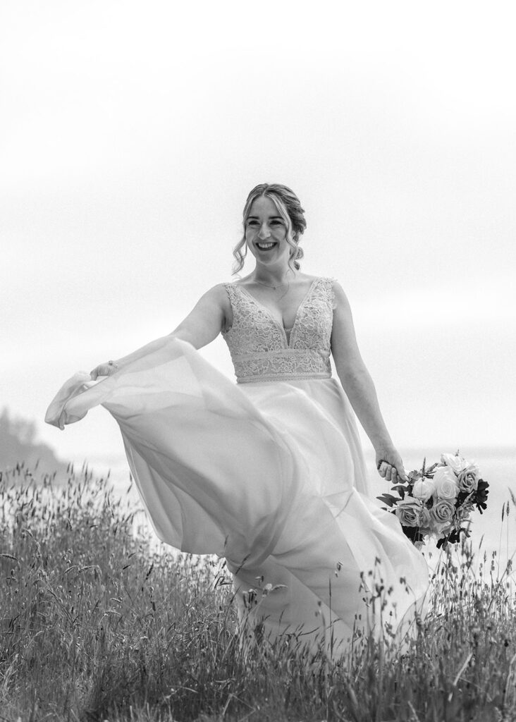 a bride smiles widely and twirls her dress among wildflowers as she dances to celebrate her elopement ceremony 