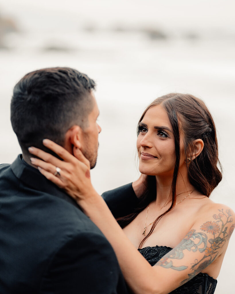 A bride embraces her groom and gazes lovingly at him during their pacific northwest elopement