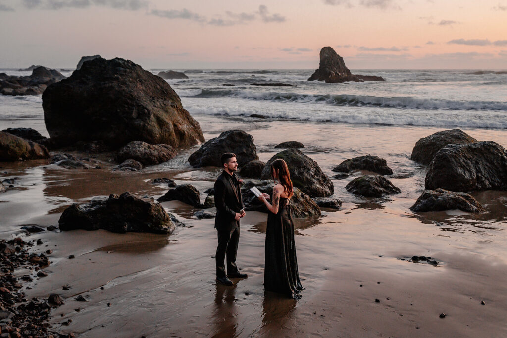 a bride reads her vows to her groom on a moody beach during their pacific northwest elopement