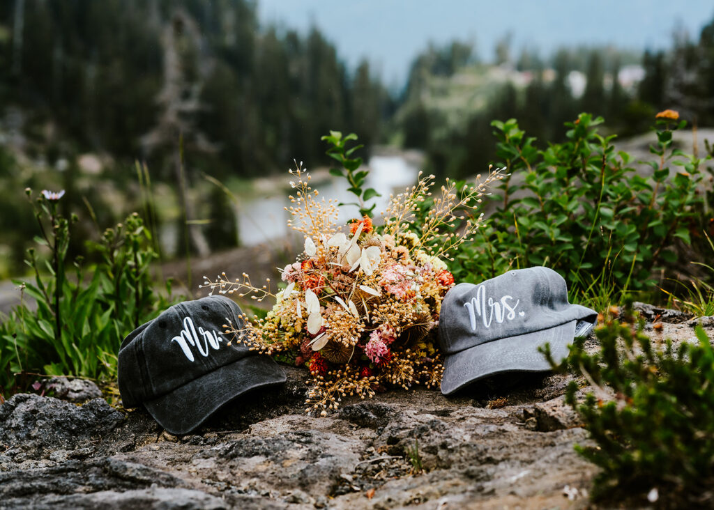 detail shots of a bridal bouquet and mr. and mrs. hats from this north cascades elopement