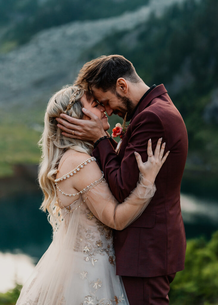 a groom holds his brides face in his hands during their north cascades elopement. 