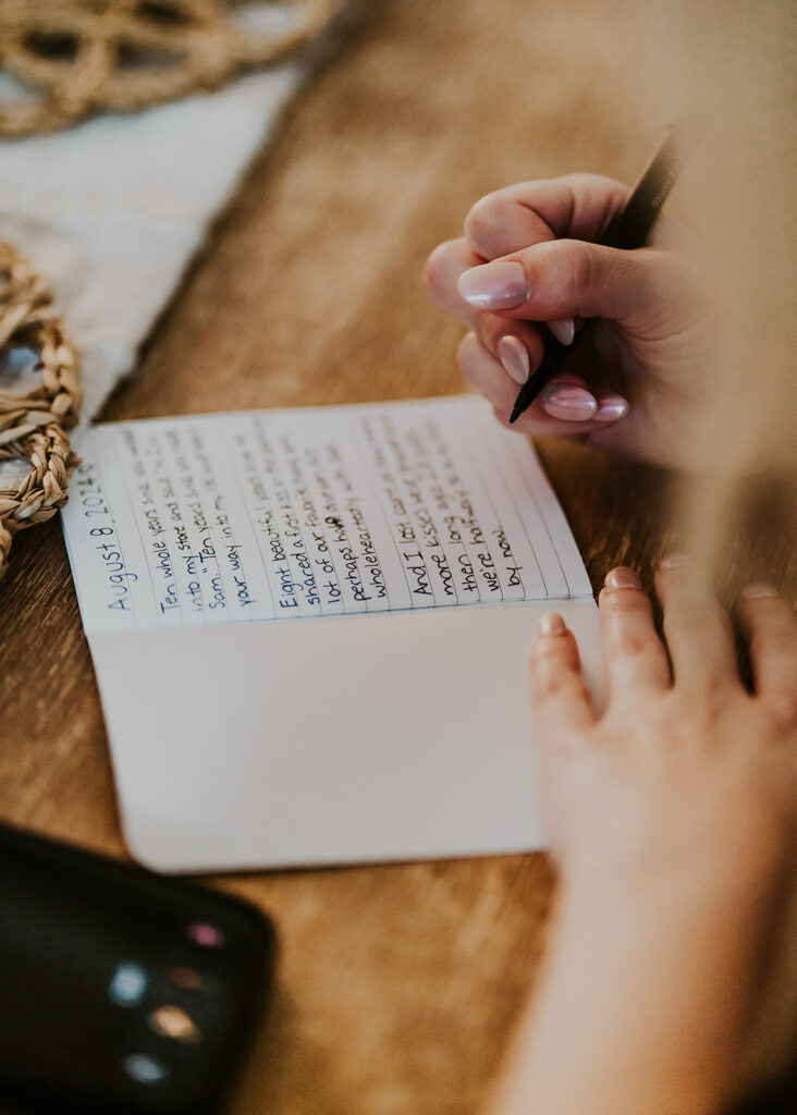 a shot of a brides hands writing her vows for her mount baker elopement taken from her perspective